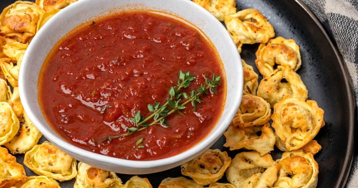 Air Fryer Recipes Close Up of Crispy Air Fryer Tortellini on a Serving Platter with a Small Bowl of Marinara Sauce