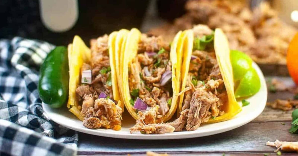 Air Fryer Recipes a Plate of Air Fryer Carnitas with Jalapenos and Lime Wedges