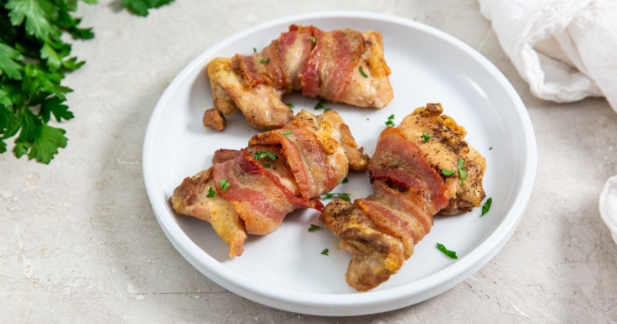 Air Fryer Recipes a Plate of Easy Air Fryer Bacon Wrapped Chicken Thighs