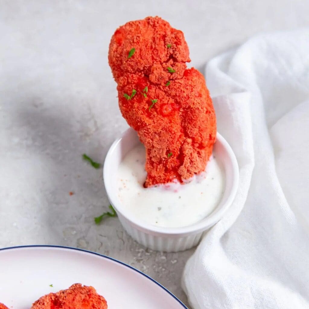 Chicken Air Fryer Hacks Close Up of Flamin Hot Cheetos Chicken Tenders Dipped in Ranch