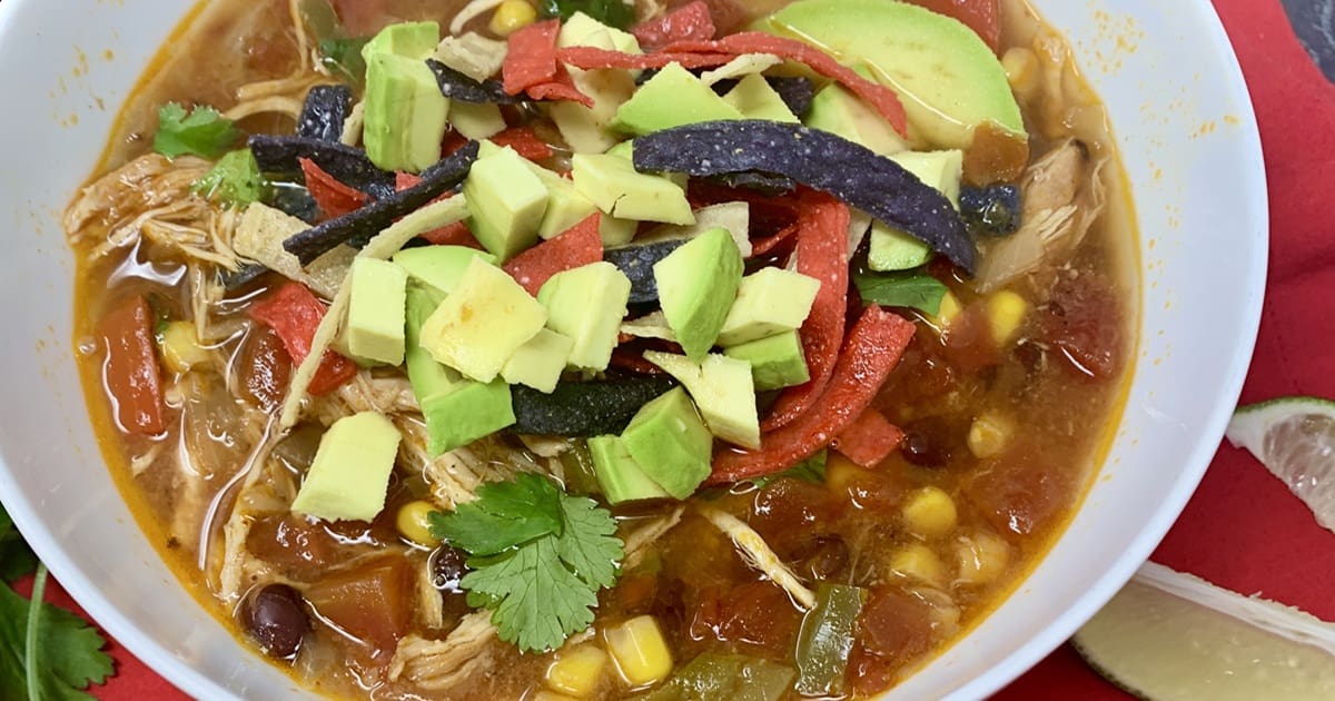 20 Easy Dinners My Family Claims Are Restaurant-Quality Close Up of a White Bowl of Crockpot Chicken Tortilla Soup