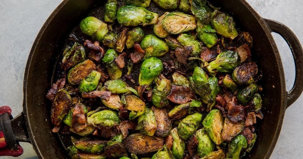 Recipes We Make Close Up of a Skillet of Sauteed Cast Iron Brussel Sprouts with Bacon