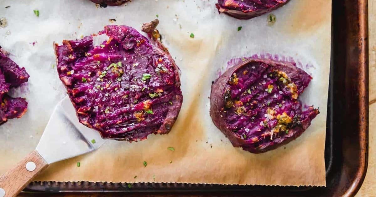 Mouthwatering Sides Roasted Purple Sweet Potatoes on a Baking Tray Lined with Parchment Paper