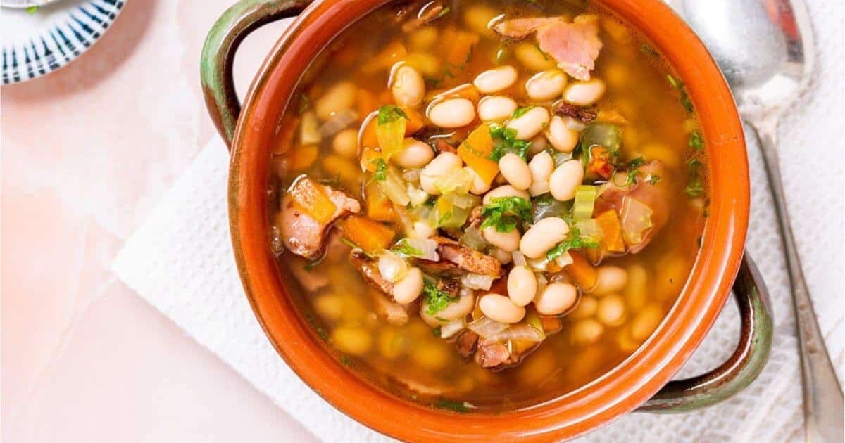 Tasty Dinners You Can Whip Up Without Breaking a Sweat Close Up of Navy Bean and Ham Soup in a Bowl