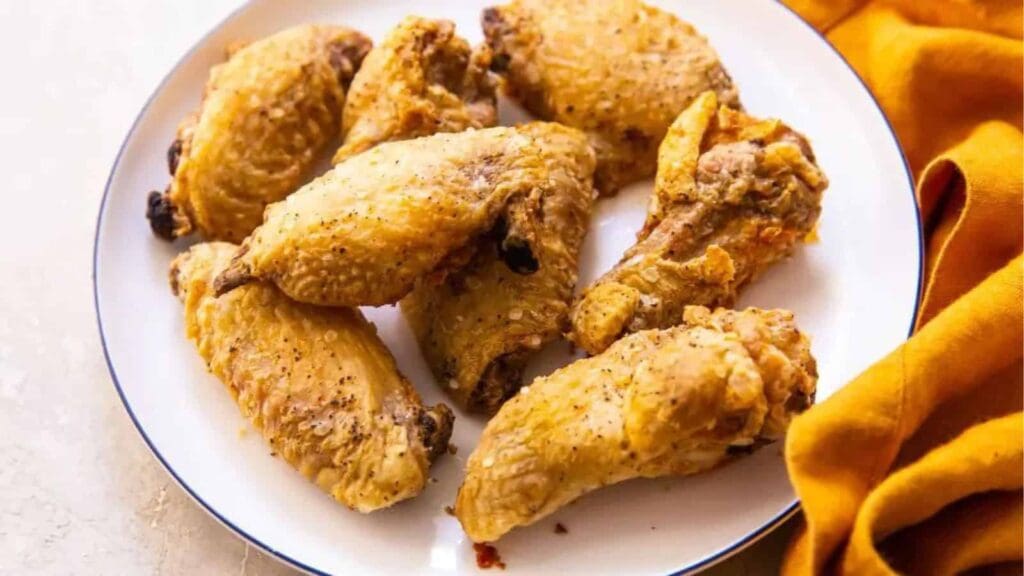 13 Must-Try Chicken Recipes Close Up of Baking Powder Chicken Wings on a White Plate