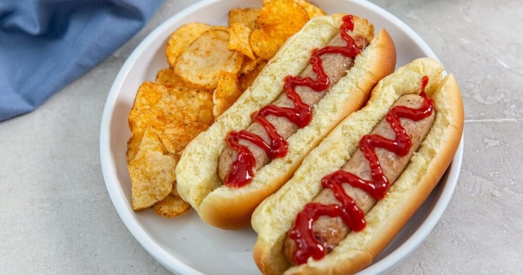 18 Fast & Flavorful Chicken Air Fryer Recipes Two Chicken Sausage Links in Buns Topped with Ketchup