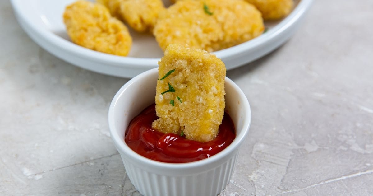 Christmas Party Air Fryer Recipes Air Fryer Trader Joe’s Chicken Nuggets Being Dipped in Ketchup