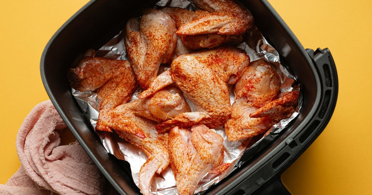 Easy Air Fryer Buffalo Wings Raw, Seasoned Chicken Wings in an Air Fryer Basket