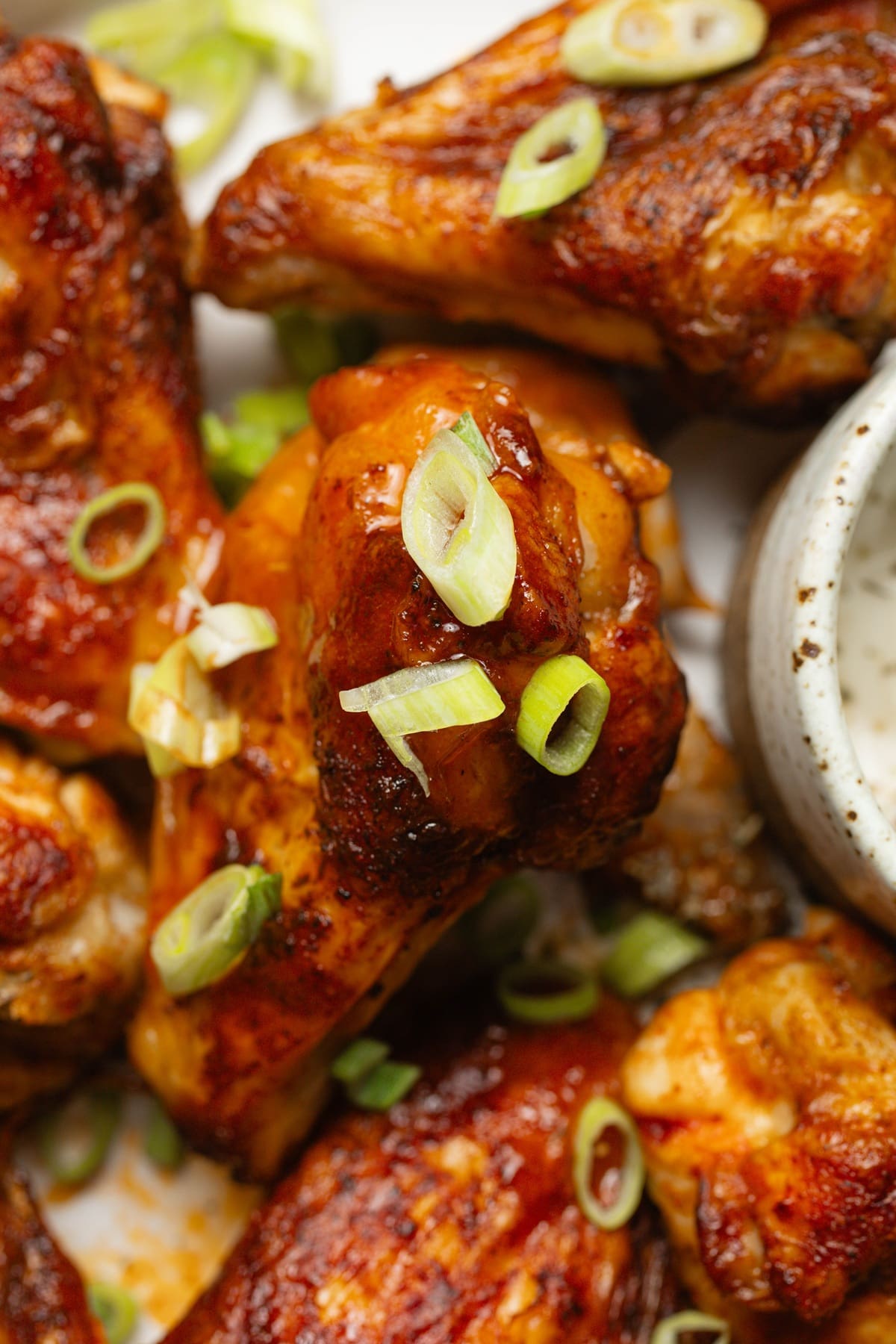 Easy Air Fryer Buffalo Wings Close Up of a Cooked Buffalo Wing on a Plate