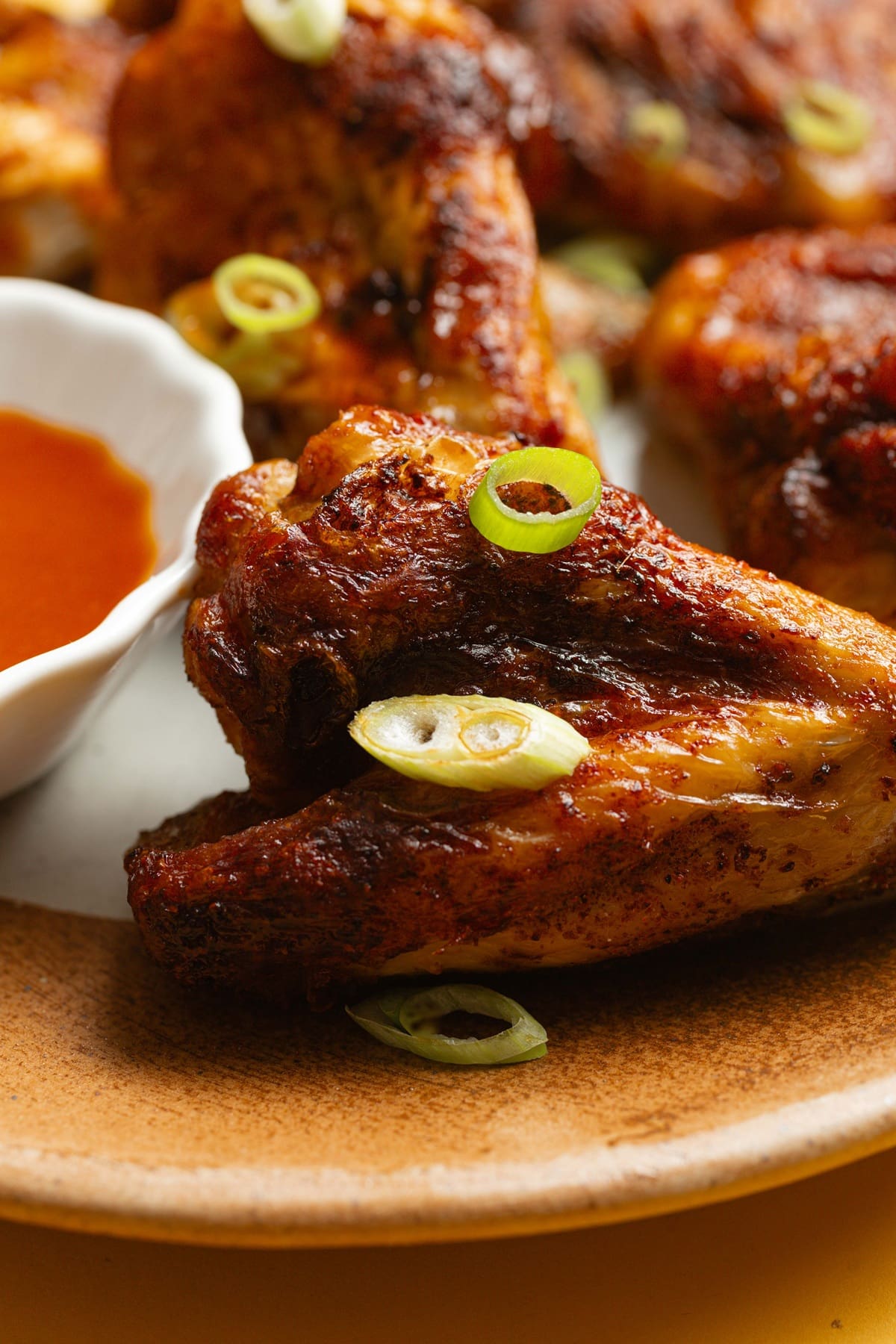 Easy Air Fryer Buffalo Wings Close Up of a Serving Platter with Wings and a Small Bowl of Buffalo Sauce