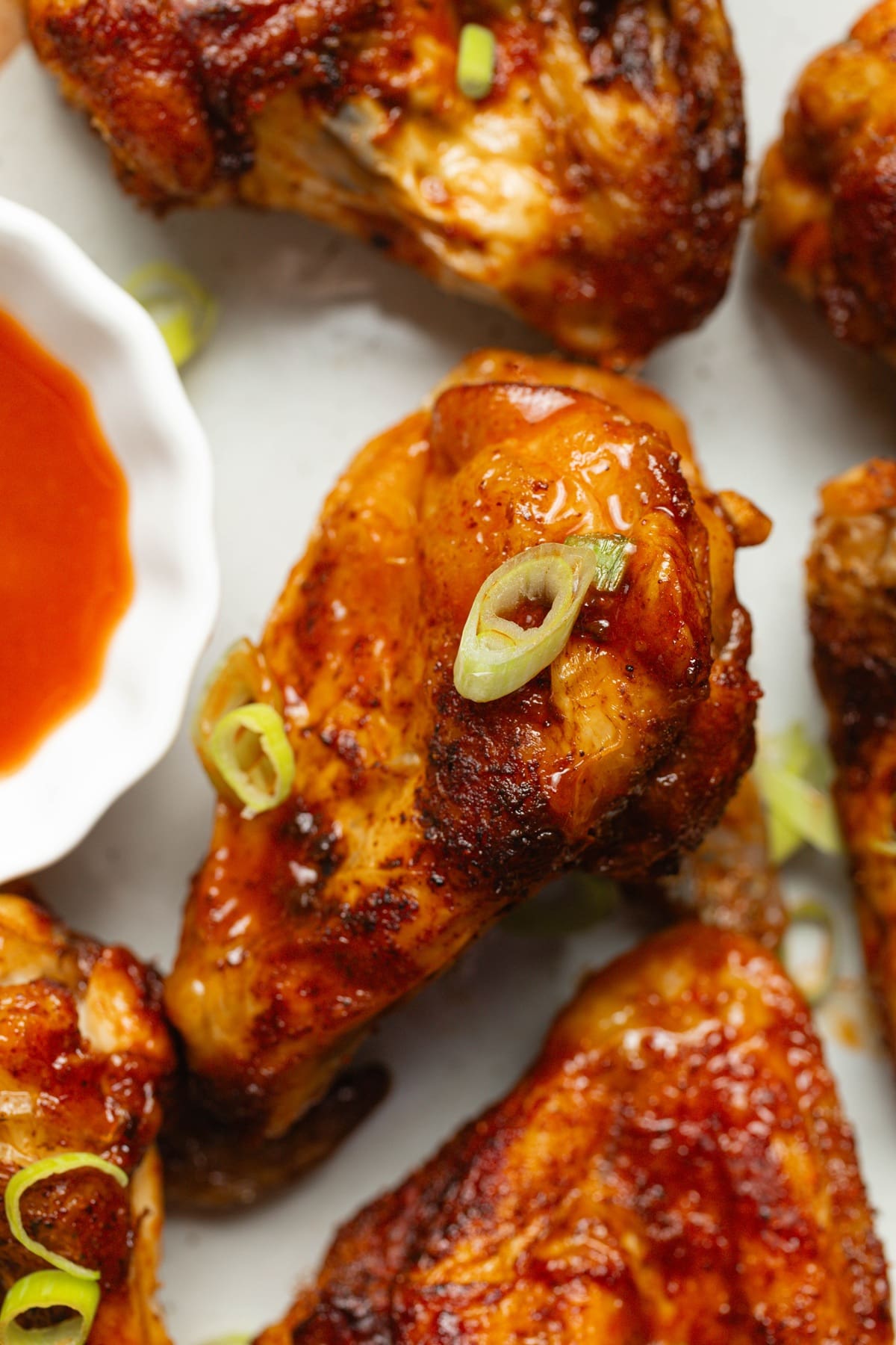 Easy Air Fryer Buffalo Wings Wings on a Plate Garnished with Green Onions