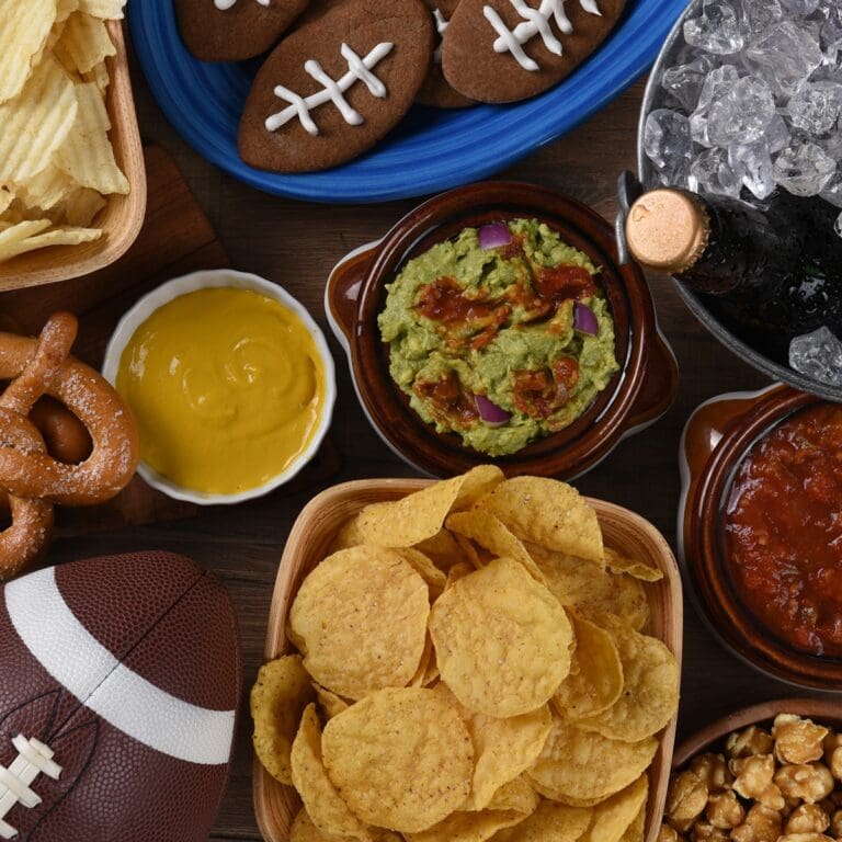 Super Bowl Air Fryer Recipes Overhead View of a Food Table with Football Themed Serving Trays