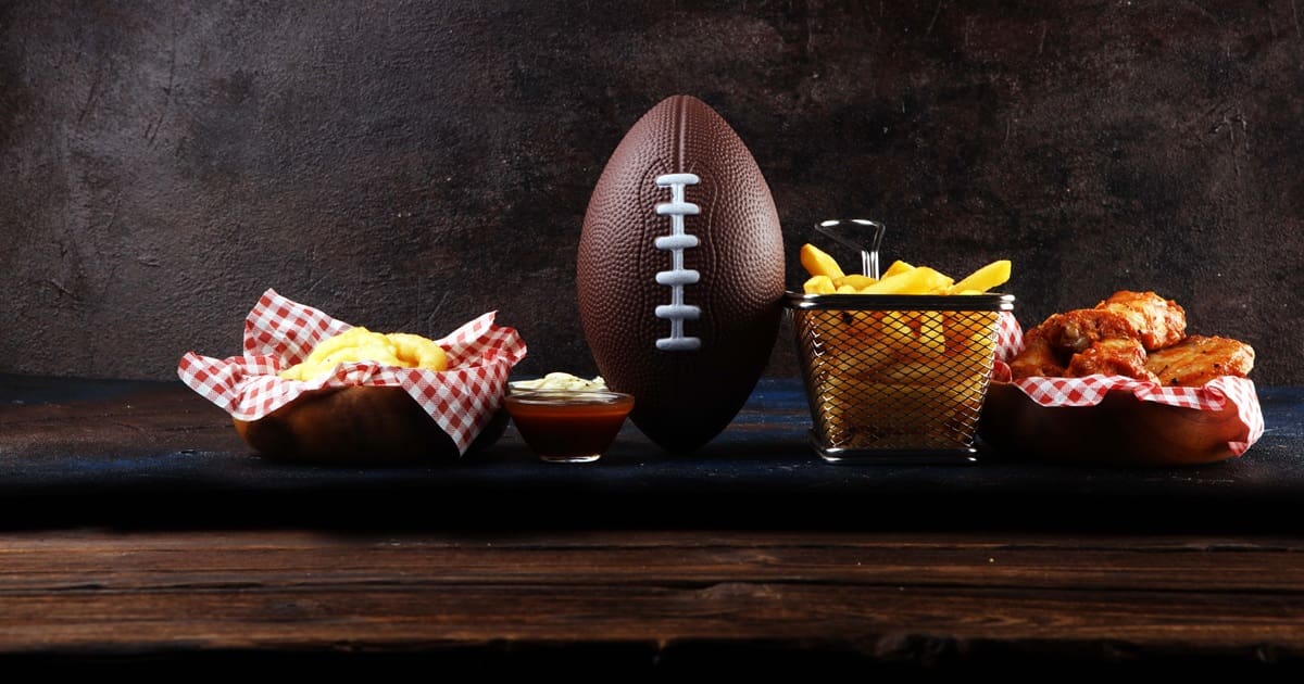 Super Bowl Air Fryer Recipes a Football Next to Baskets of Food