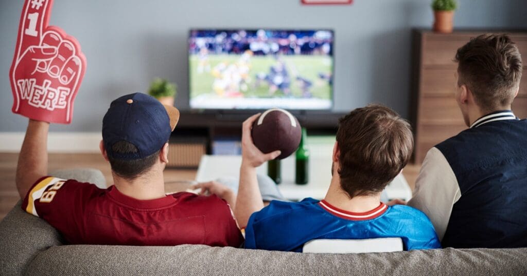 Super Bowl Air Fryer Recipes Two Men Sitting on a Couch Watching Football and Cheering