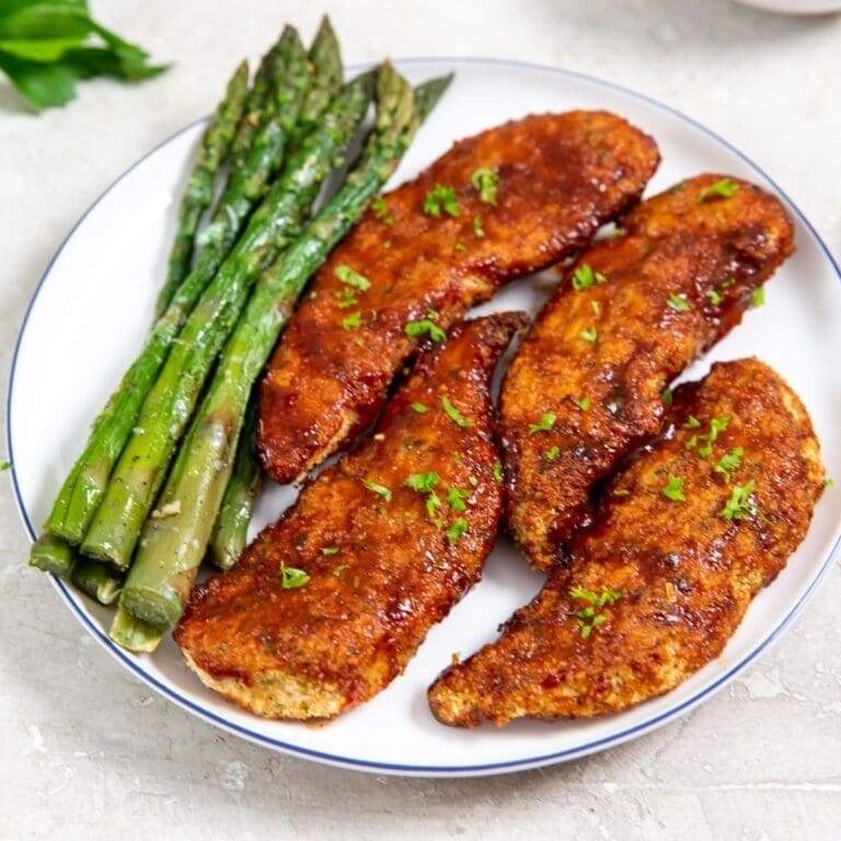 Valentine's Day Snacks for Kids a Plate of Chicken Strips with Asparagus on a White Plate