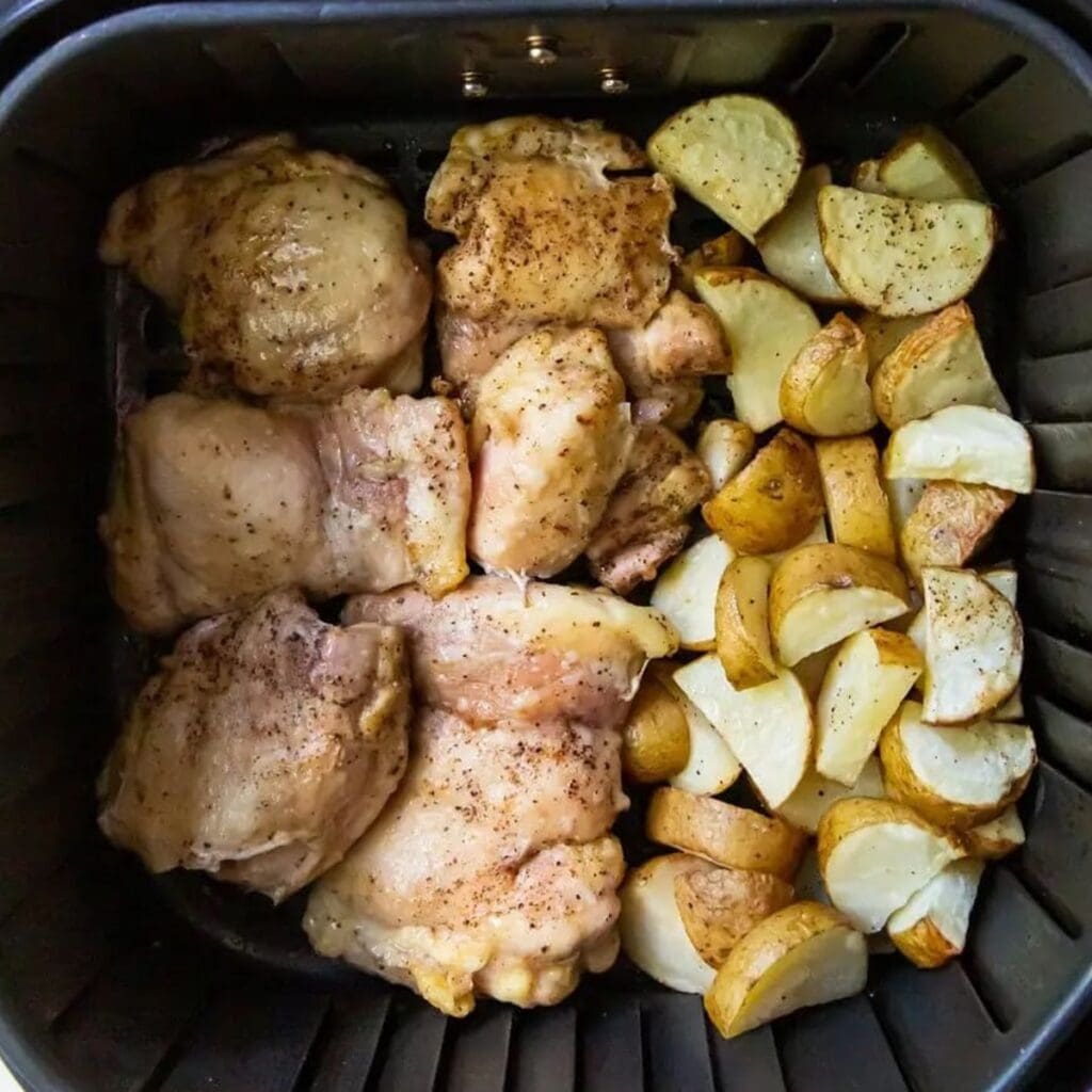 Chicken Air Fryer Recipes Delivery Can’t Compete With Close Up of Chicken and Potatoes in an Air Fryer Basket