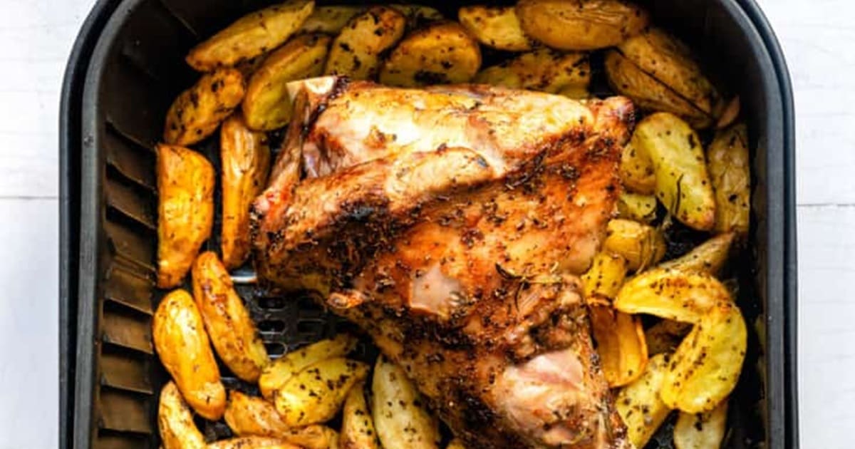 Air Fryer Easter Recipes Close Up of Cooked Lamb Shank and Potatoes in an Air Fryer Basket