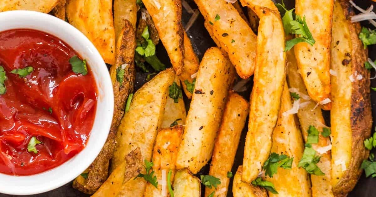 Memorial Day Air Fryer Recipes Close Up of Air Fryer French Fries with a Small Ramekin of Ketchup