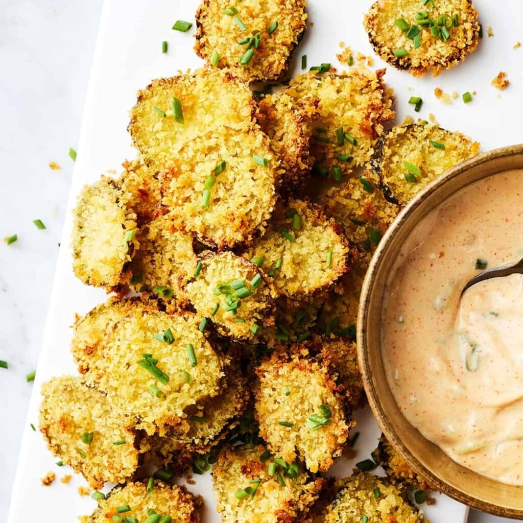 Must Make Memorial Day Recipes in your Air Fryer Close Up of Fried Pickles Next to a Small Dish of Dipping Sauce
