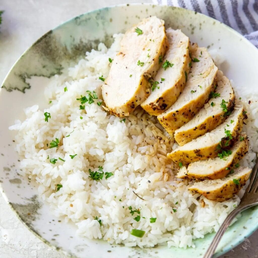 Tasty Chicken Recipes Close Up of a Bowl of Rice Topped with Sliced Chicken