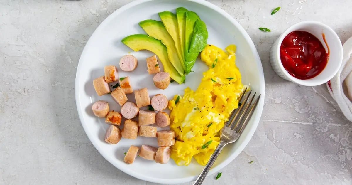 Air Fryer Chicken Sausage Recipes Close Up of a Plate of Air Fryer Trader Joe’s Chicken Breakfast Sausage with Scrambled Eggs and Avocado Slices