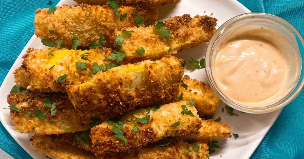 Summer Squash Air Fryer Recipes Close Up of Squash Fried with a Small Ramekin of Burger Sauce Next to it