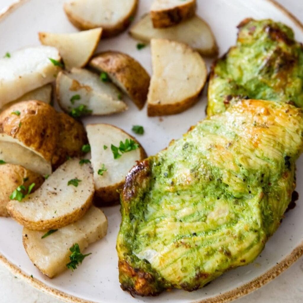 Tasty Chicken Recipes Close Up of Pesto Chicken on a Plate with Roasted Potatoes