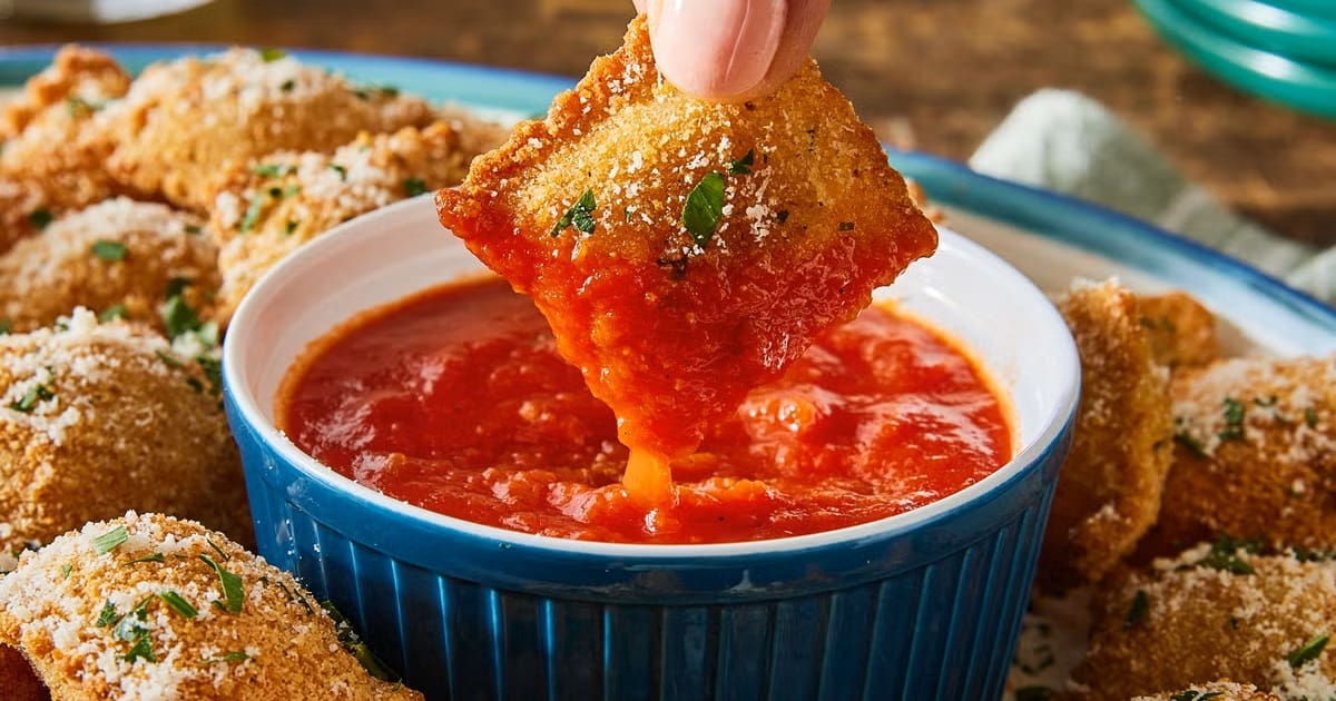 Fall Air Fryer Recipes Air Fryer Ravioli Being Dipped into Marinara Sauce