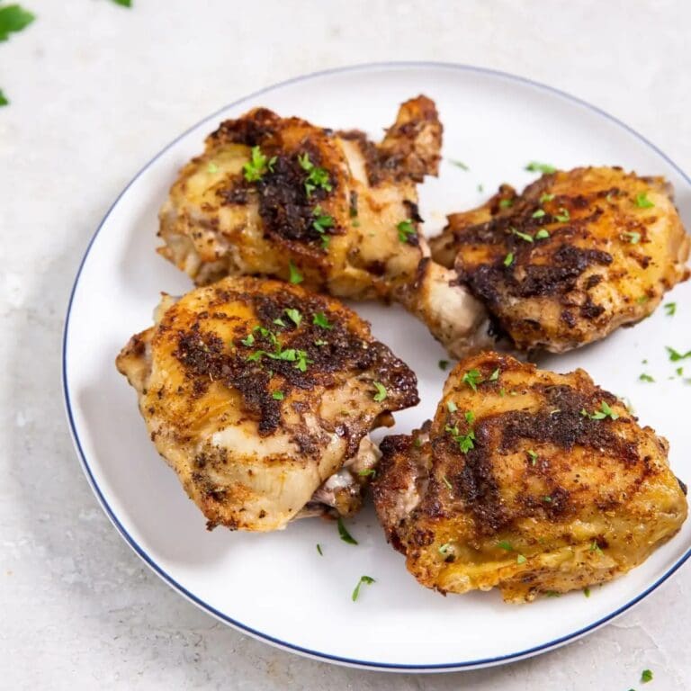 Secrets to Best Air Fryer Chicken Thighs a Plate of Cooked Chicken Thighs