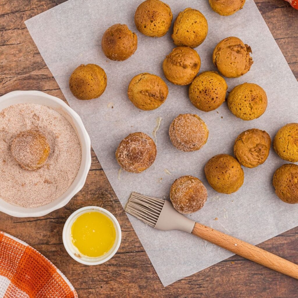 Air Fryer Halloween Recipes Overhead of Pumpkin Spice Donut Holes on a Sheet of Parchment Paper