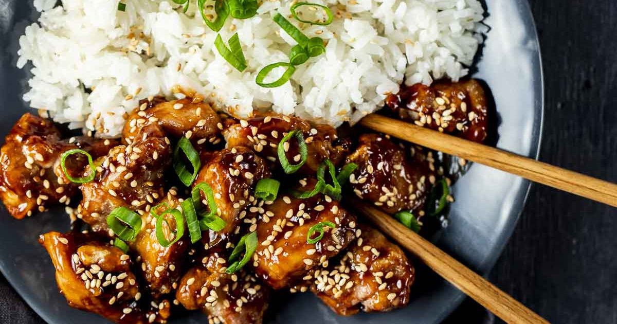 Must-Try Chicken Air Fryer Recipes for Stress-Free Meals Close Up of Air Fryer Sesame Chicken in a Bowl with Rice