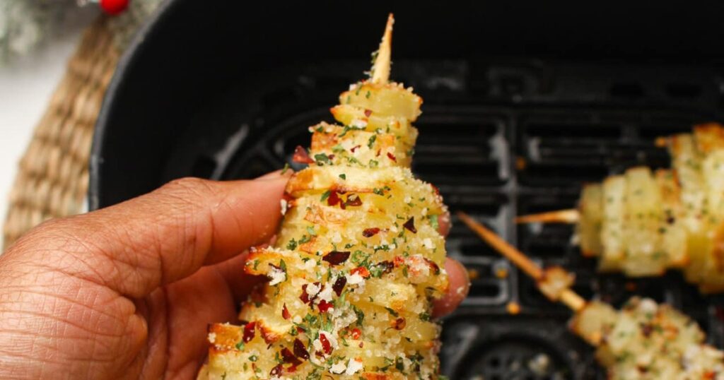 Air Fryer Christmas Party Recipes Close Up of a Christmas Potato Tree in a Person's Hand