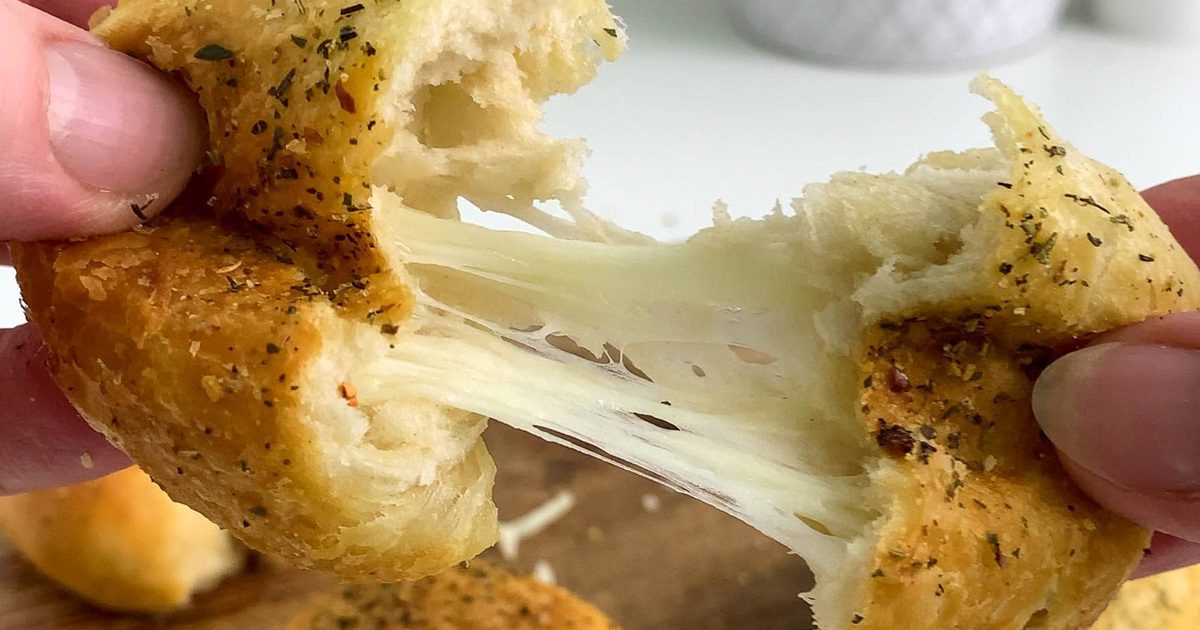 New Year's Eve Snacks Close Up of Garlic Cheese Balls with Gooey Mozzarella Being Pulled Apart to Show the Cheese