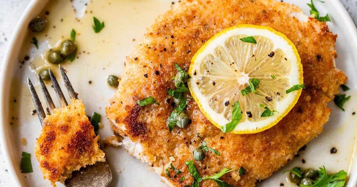 Chicken Dinners So Good Air Fryer Chicken Piccata on a Plate with a Lemon Slice Garnish