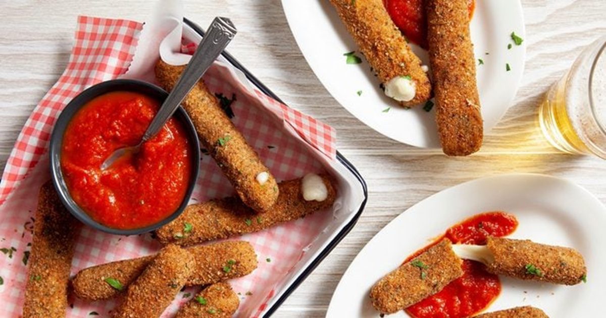 New Year's Eve Snacks Over head of Air-Fryer Mozzarella Sticks on a Serving Tray with a Small Dish of Marinara Sauce