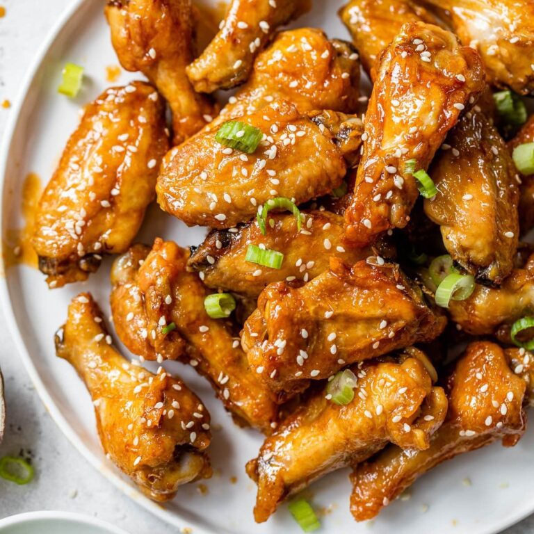 Chicken Dinners So Good CLose Up of Sauced Wings Garnished with Sesame Seeds on a Plate
