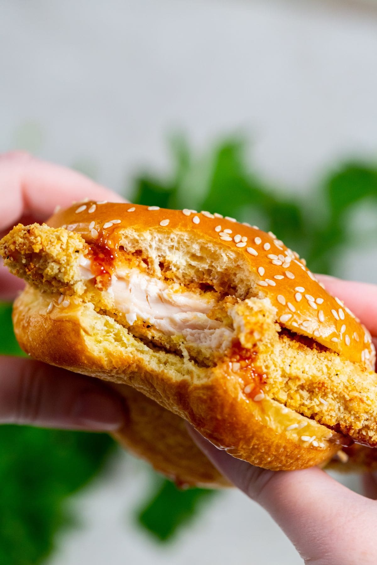 Close Up of a Air Fryer Katsu Chicken Sandwich with a Bite Taken From it Being Held in Two Hands 