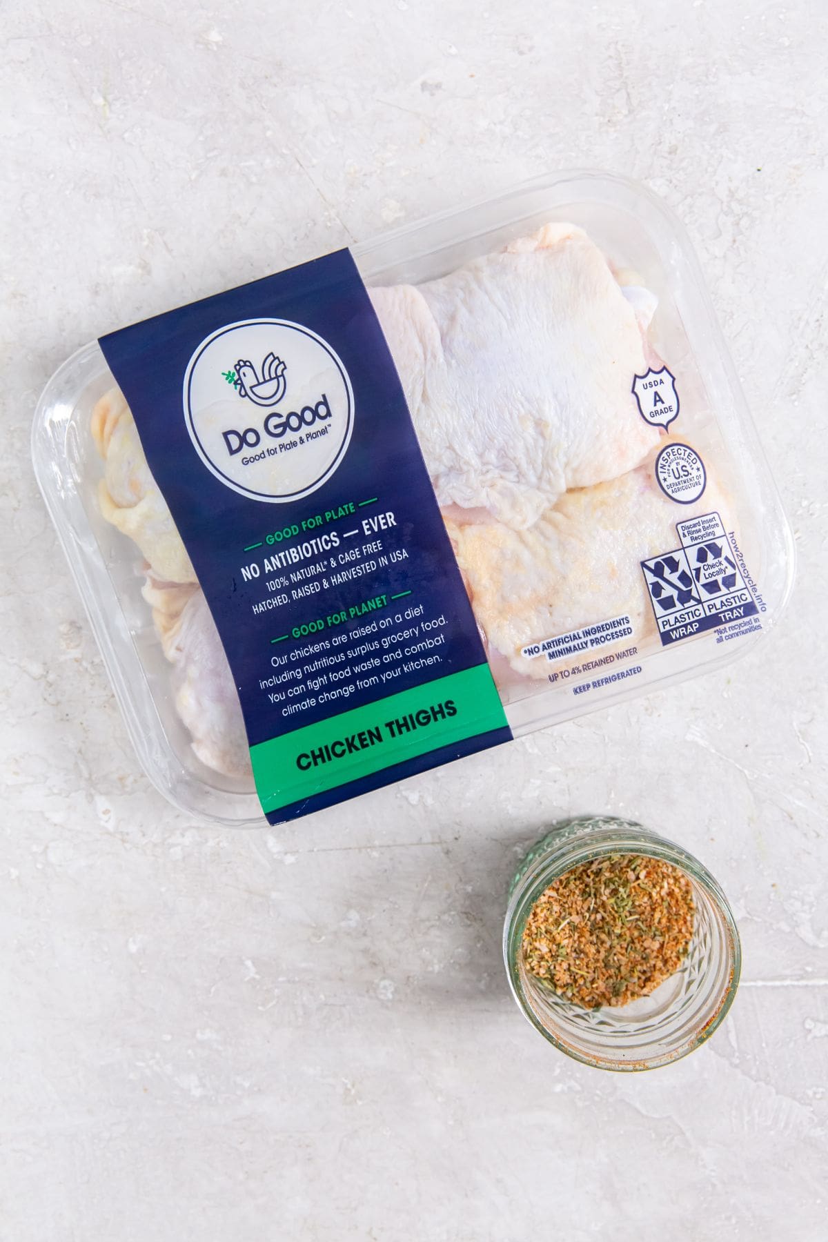 Air Fryer Keto Chicken Thighs Raw Chicken Thighs in a Package Next to a Small Ramekin of Dry Rub