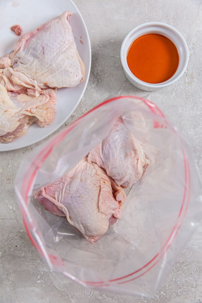 Air Fryer Buffalo Chicken Thighs ziplock bag with chicken inside