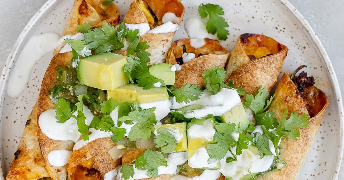 Air Fryer Easter Brunch Recipes Air Fryer Breakfast Taquitos Topped with Avocado Pieces Cilantro and Sour Cream on a Plate