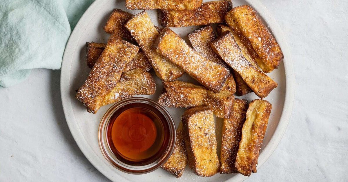 Air Fryer Easter Brunch Recipes Air Fryer French Toast Sticks on a Plate with a Small Ramekin of Syrup