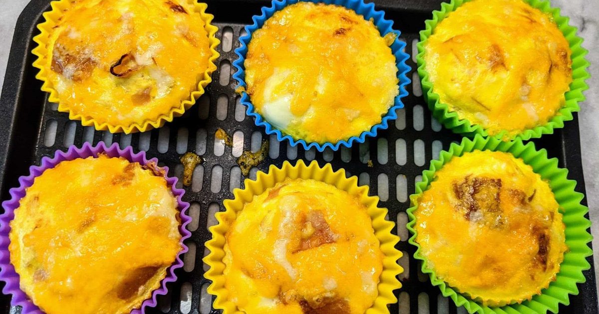 Air Fryer Easter Dinner Recipes Close Up of Air Fryer Mini Egg, Ham, and Cheese Quiches in Small Paper Cups on a Cooling Rack