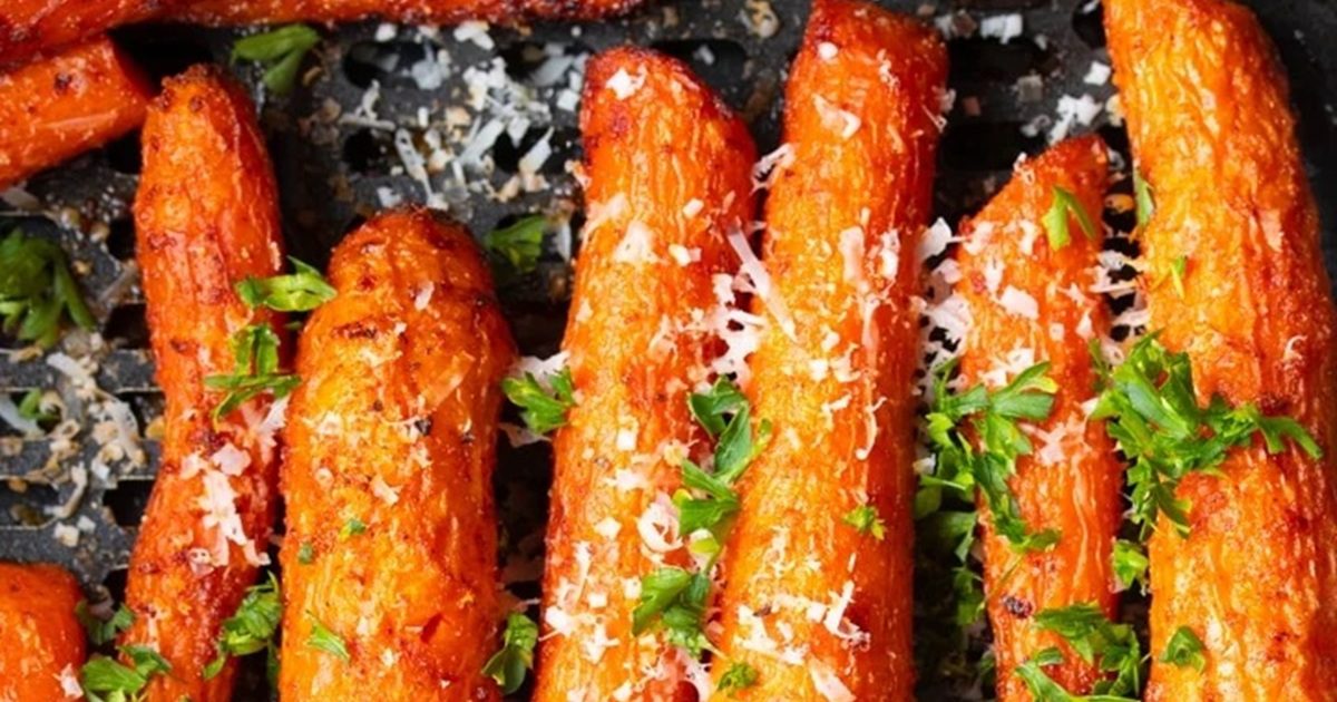 Air Fryer Easter Dinner Recipes Close Up of Air Fryer Carrots in an Air Fryer Basket Garnished with Parmesan and Parsley 