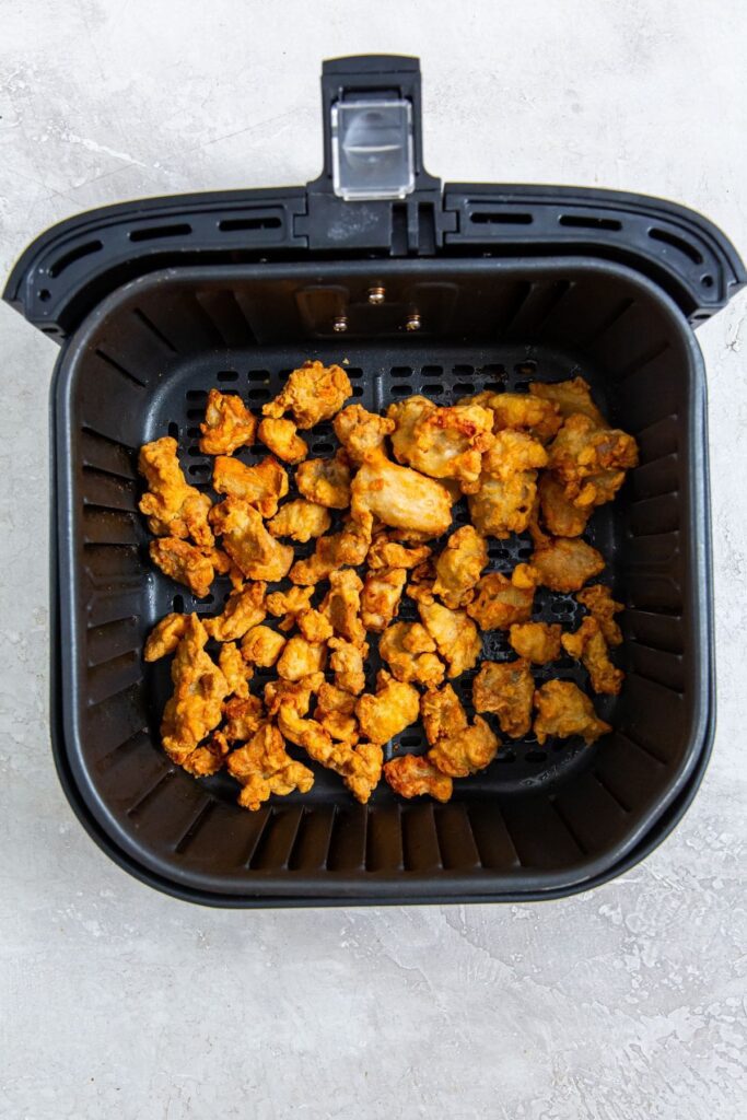 Air Fryer Trader Joe&rsquo;s Orange Chicken black air fryer with cooked chicken inside