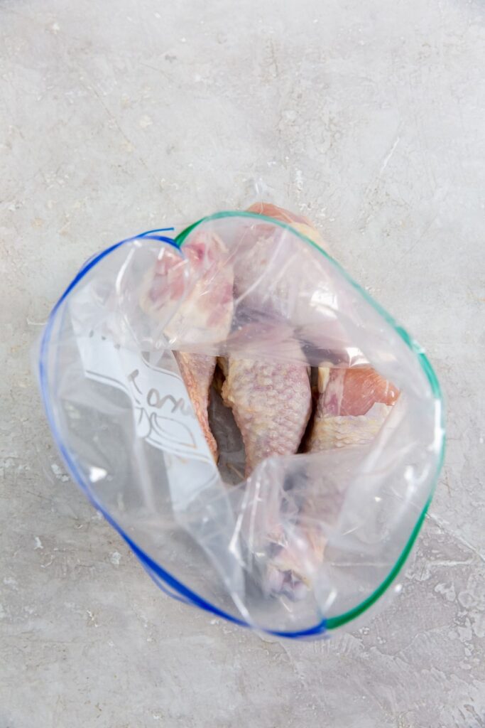 Air Fryer Buffalo Chicken Legs the chicken inside a ziplock bag
