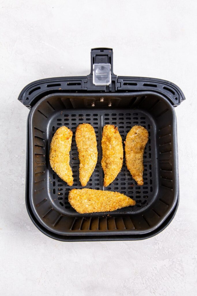 Air Fryer Shake N Bake Chicken Tenders black air fryer with cooked chicken inside