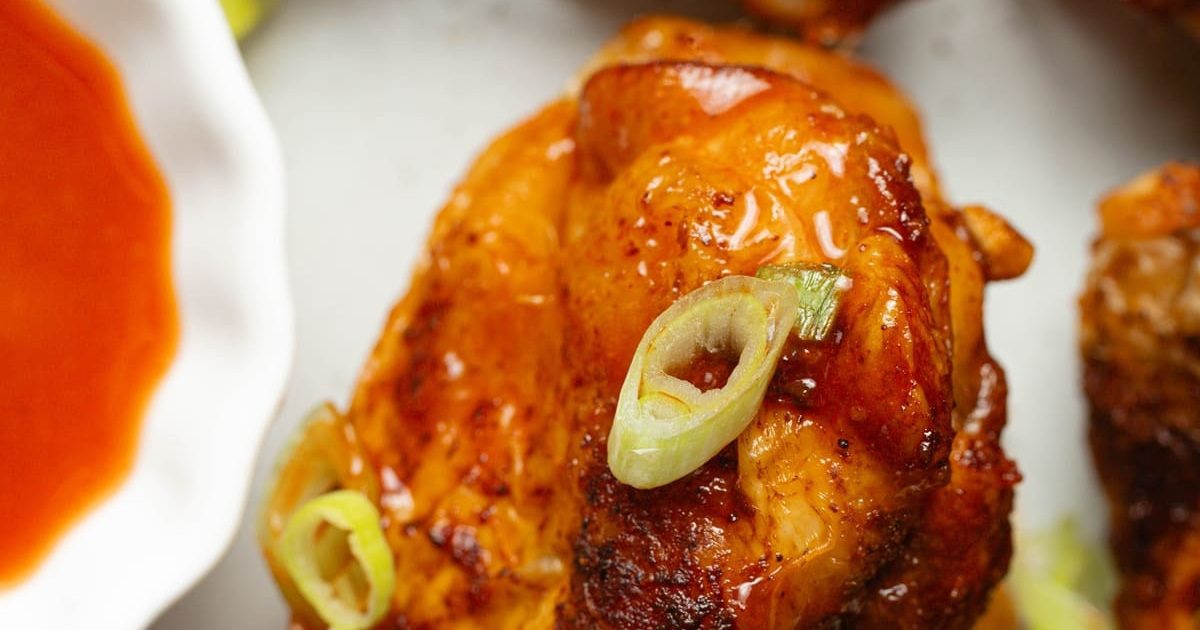 Dinner Ideas for Two Close Up of Easy Air Fryer Buffalo Wings Next to a Small Bowl of Buffalo Sauce