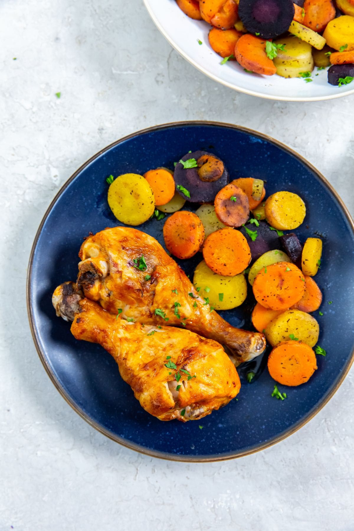 Air Fryer Buffalo Chicken Legs blue plate with chicken and carrots on it