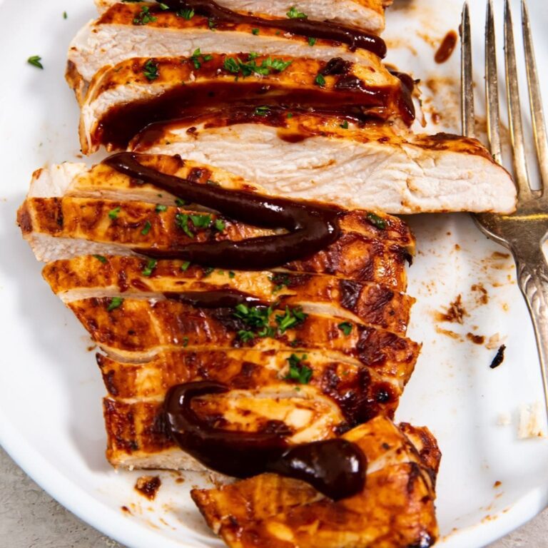 Foolproof Chicken Air Fryer Recipes Close Up of Sliced BBQ Chicken Breast on a Plate with a Fork
