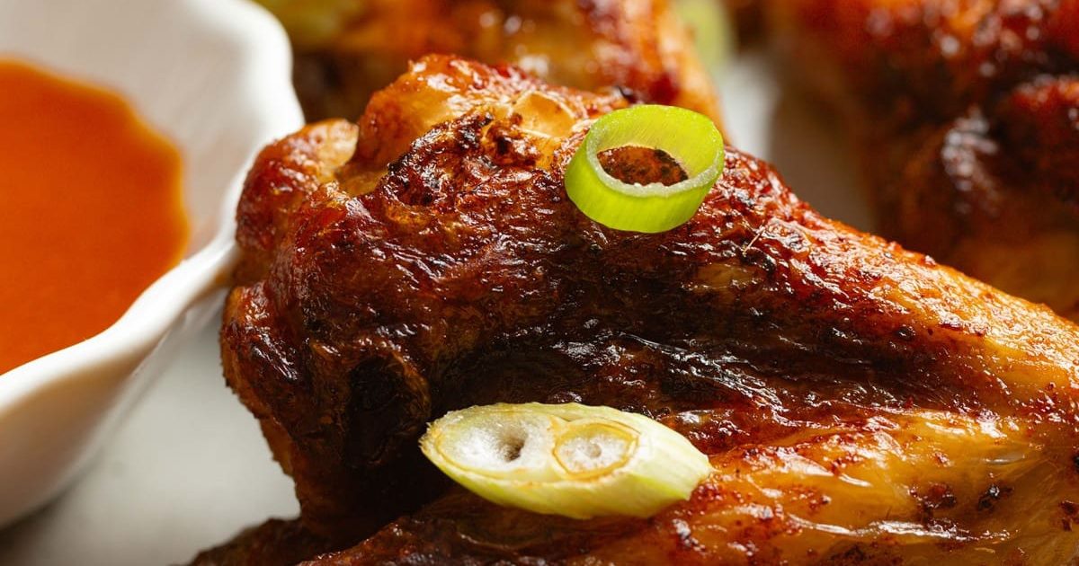 Foolproof Chicken Air Fryer Recipes Close Up of Easy Air Fryer Buffalo Wings Garnished with Diced Green Onions